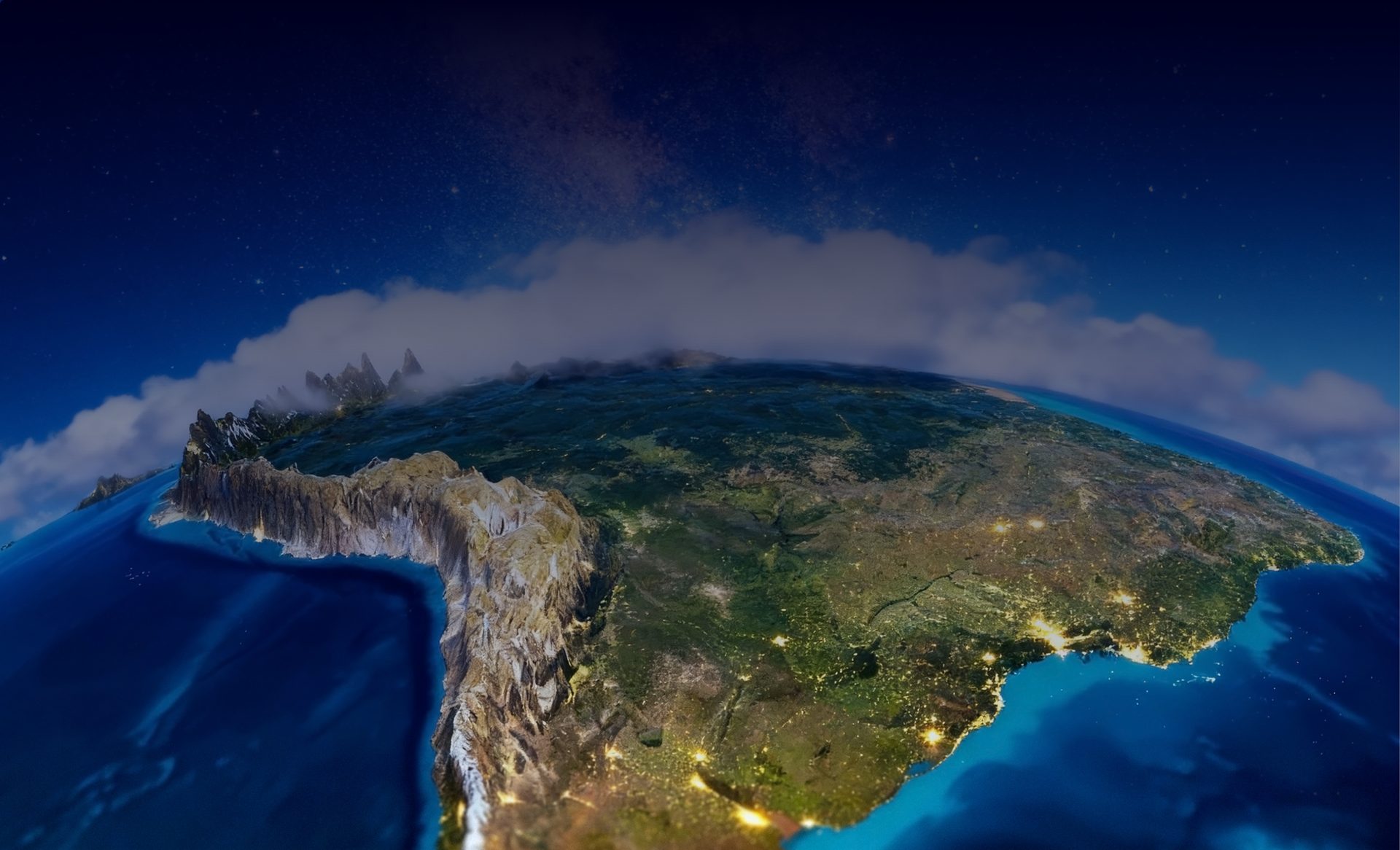 La Tierra vista desde el espacio de noche, con las luces de las ciudades y la franja del amanecer